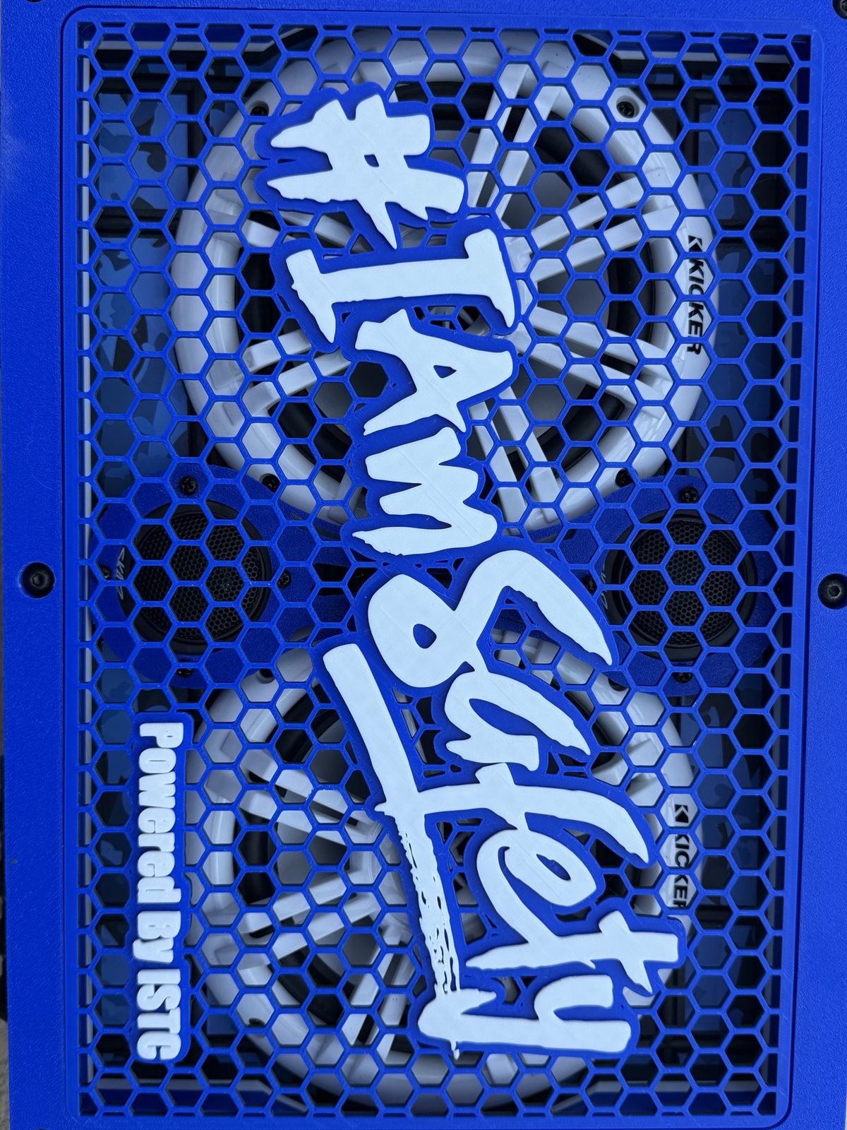 Close-up of layered 3D-printed lettering on the grill